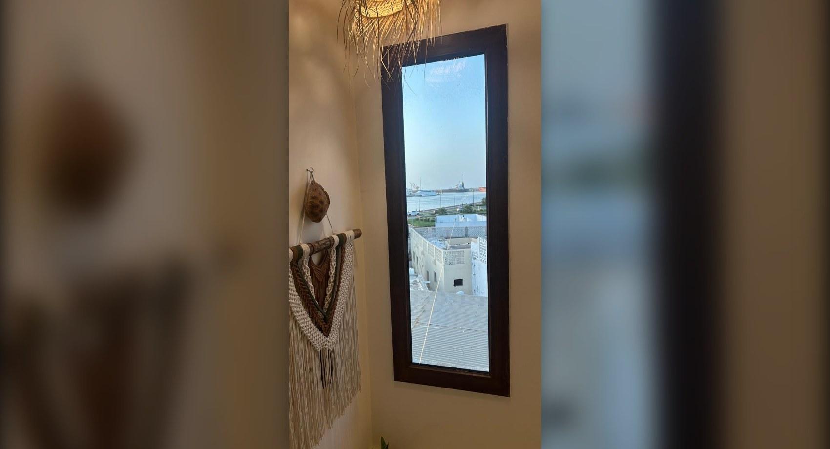 Window view over old Muttrah and the harbour
